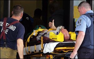 A male shooting victim gives the thumbs up as he is carried out on a stretcher after being shot.<br>
<img src=http://www.toledoblade.com/graphics/icons/photo.gif> <b><font color=red>VIEW PHOTO GALLERY:</font></b> <a href=