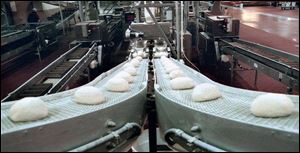 Dough heads for ovens inside the Interstate bakery in Northwood. The owner is in bankruptcy and the plant could be sold.