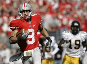 The Buckeyes' Brian Hartline finishes off a 90-yard punt return for a touchdown. The return broke a 57-year-old record.