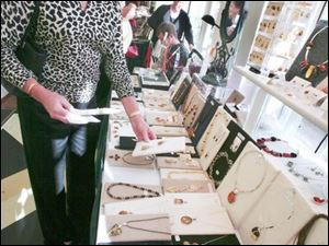  Sandi Sydlowski of holland looks over Amberardo  (amber) jewelry