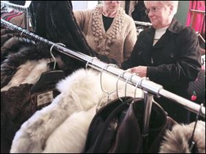 Sara North of Perrysburg, from left, and Dottie Wilkerson of Sylvania look over coats that were on sale.