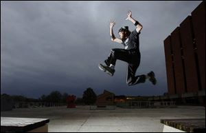 Mike Schiewer leaps while practicing the French sport parkour at Bowling Green State University.