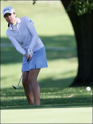 St. Ursula's Ashley Garrison chips onto the green on the 18th hole of the Gray Course. She shot 81 Friday and yesterday.