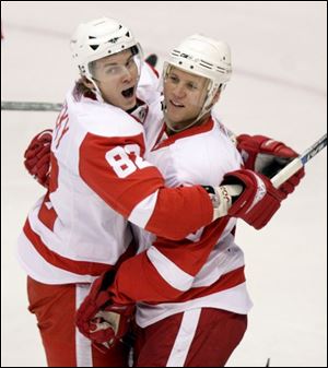 Detroit left winger Kirk Maltby, right, is congratulated on his first of two goals Saturday night by Tomas Kopecky.
