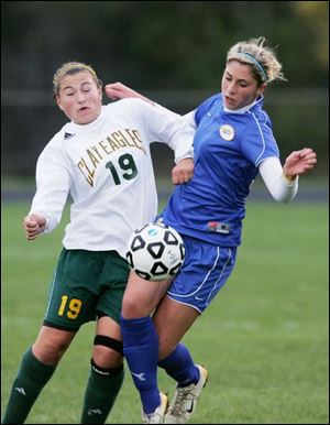 Clay's Alexis Donnelly and St. Ursula's Megan Gallagher try to gain possession in last night's district semifinal match.
