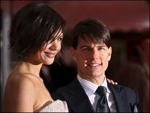 U.S. actor Tom Cruise, right, and his wife Katie Holmes arrive at the German premiere of his latest movie 'Lions for Lambs' at "Kino International" on Wednesday Oct. 24, 2007, in Berlin, Germany. The movie directed by Robert Redford will be on German screens starting Thursday, Nov. 8, 2007. (AP Photo/Miguel Villagran)