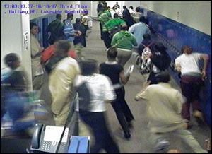 Cleveland Police Department In this still image taken from a surveillance camera, SuccessTech Academy students flee during the Oct. 10 shooting rampage. 