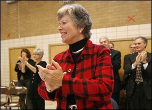Frances Strickland applauds enthusiastically during a performance by children in the Bowling Green State University Kindergarten Project. 