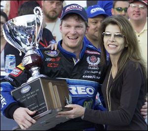 In happier times, Dale Earnhardt Jr. and his stepmother, Teresa Earnhardt, share a hug after a victory in Daytona in 2002.