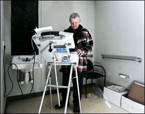 Steven Hile casts an absentee ballot in the temporary Hancock County Board of Elections headquarters in Findlay.
