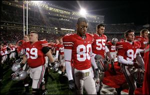 Ohio State wide receiver Brian Robiskie (80) and teammates walk off the field after losing to Illinois  28-21, in a college football game Saturday, Nov. 10, 2007 in Columbus, Ohio. 