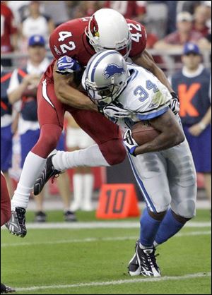 Cardinals' Terrence Holt is unable to keep Detroit's Kevin Jones from scoring Sunday. The Lions lost 31-21 to Arizona.