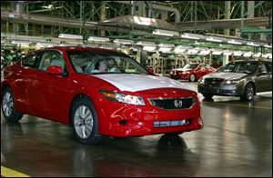 A 2008 Honda Accord coupe is driven off the assembly line at the Marysville plant that opened 25 years ago. 