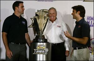 Jimmie Johnson, left, is probably reminding owner Rick Hendrick, center, how Jeff Gordon recommended him for a job.