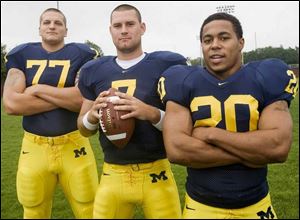 Jake Long, left, Chad Henne, center, and Mike Hart each had a chance to leave for the NFL after their junior seasons, but they are each missing one big item on their resumes   a victory against Ohio State.
