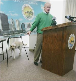 <br>
• Yesterday morning:
Government Center s manager told Mayor Carty Finkbeiner,
left, that he could no longer bring his dog, Scout, to work.
<br>
• Yesterday afternoon:
The building s owner said Scout
could go to work with the mayor today while the two parties
attempt to reach an agreement.
<br>
• Health benefit? Building officials say the mayor has told
them he needs the dog for stress reduction. The mayor s spokesman said yesterday that is a private matter.