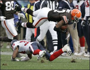 The Browns' Braylon Edwards has his feet taken out by the Texans' Von Hutchins. 