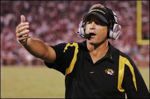 Missouri coach Gary Pinkel, who was 73-37-3 at Toledo from 1991-2000, gestures on the sidelines in the closing minutes of a football game against Oklahoma in Norman, Okla., Saturday, Oct. 13, 2007. 