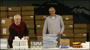 The Rev. Roger Miller, left, and the Rev. Tom Schaeffer prepare to assemble caregiver kits for HIV/AIDS sufferers.
