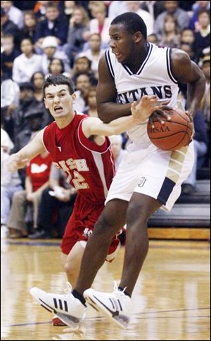 St. John's Tim Kynard hangs on to one of his 11 rebounds as Central's Cory Lehman tries to steal it.
<br>
<img src=http://www.toledoblade.com/assets/gif/weblink_icon.gif> <b><font color=red>VIEW</b></font color=red>: <a href=