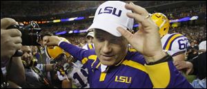 LSU coach Les Miles, an Ohio Native, played host to the Ohio State coaching staff during the Tigers' spring workouts.