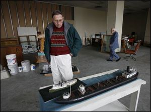 Bob Brooks and Harry Archer of the Western Lake Erie Historical Society look over the display items that now are stored at the former DeVilbiss facility on Phillips Avenue.