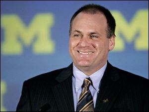 New UM coach Rich Rodriguez.
<br>
<img src=http://www.toledoblade.com/assets/gif/weblink_icon.gif> <b><font color=red> ALSO ONLINE:</font></b> <a href=" /apps/pbcs.dll/article?AID=/20071219/NEWS02/328748867" target="_blank "><b> Terminated arena consultant threatens suit</b></a>
<br>
<img src=http://www.toledoblade.com/assets/gif/weblink_icon.gif> <b><font color=red> ALSO ONLINE:</font></b> <a href=" /apps/pbcs.dll/article?AID=/20071219/NEWS16/712190394" target="_blank "><b>COSI closing as planned Dec. 31</b></a>