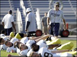 Michigan coach Lloyd Carr watches his Wolverines loosen up for practice getting ready for the Capital One Bowl on Jan. 1.