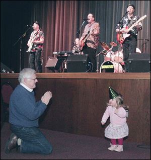 CTY light01p 5 12/31/2007   BLADE PHOTO/Lori King    Sylvania resident Bob Kelso encourages his granddaughter, Waterville, Ohio resident Greta Kelso, 2, to dance to band Bonkers, during First Light at Franciscan Center in Sylvania, Ohio.