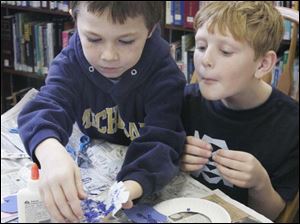 NBRN winter03p 1 12/28/2007   BLADE PHOTO/Lori King    Luna Pier, Mich. residents Robert LeFever, 9, and Chad Poca, 8, decorate cut-out snow flakes during Winter Wonderland Craft party at Rasey Memorial Branch Library in Luna Pier, Mich.