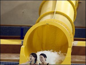 Slug:  NBR splash04p     Date: 12/29/2007         The Blade/Andy Morrison       Location:  Maumee      Caption: Samantha McDonald, 6, and her mother Debbie McDonald enjoy a water slide at Holiday Inn Splash Bay Resort. The Raleigh, North Carolina family was visiting relatives and having fun at the park, Saturday, 12/28/2007.       Summary: