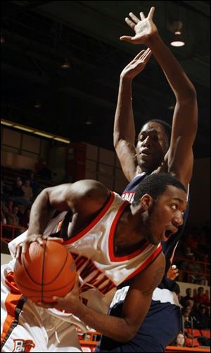 Bowling Green's Chris Knight tries to slip past a Duquesne defender last night in Anderson Arena. Knight scored 14 points but the Falcons' record slipped to 5-7.