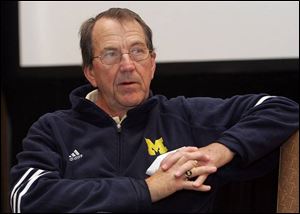 Now retired coach Lloyd Carr relaxes yesterday after Michigan's victory New Year's Day. He finished 122-40 in 13 seasons.