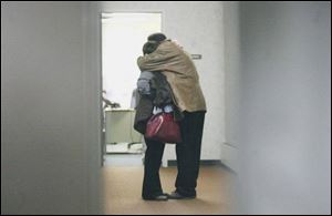 Relatives of Mr. Gagnon console one another in a court hallway after his arraignment.