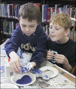 NBRN winter03p 1 12/28/2007   BLADE PHOTO/Lori King    Luna Pier, Mich. residents Robert LeFever, 9, and Chad Poca, 8, decorate cut-out snow flakes during Winter Wonderland Craft party at Rasey Memorial Branch Library in Luna Pier, Mich.