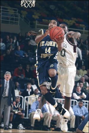 Cheatham Norrils of St. John's goes up for a basket at Savage Hall with David McDonald of Scott following close on his heels. The freshman guard scored nine points for the Titans. (THE BLADE/LORI KING)
<br>
<br>
<img src=http://www.toledoblade.com/graphics/icons/photo.gif> VIEW: <a href=