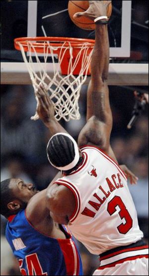 Bulls center Ben Wallace dunks over the Pistons' Jason Maxiell. Wallace finished the game with six points.