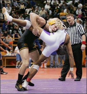 Waite's Alex Herrick, left, puts down Maumee's Mikkal Johnson in the 140-pound final. Herrick won the title with a 14-3 win.