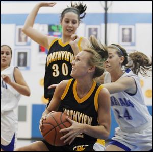Northview's Karly Kasper goes to the basket in front of teammate Katelyn Dobson and Anthony Wayne's Briege Donahue in Saturday's game.