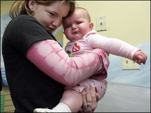 NBRN kids31p  3 01/23/2008   BLADE PHOTO/Lori King    Bedford High School sophomore Jessica Foust tries to comfort toddler Gabrielle Stout in the Toddler Trail room during MOPS (Mothers of Preschoolers) program at Crossroads Community Church in Ottawa Lake, Mich.