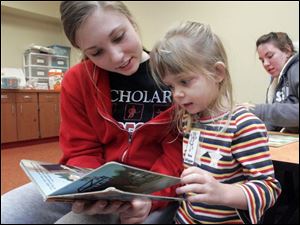 NBRN kids31p  2 01/23/2008   BLADE PHOTO/Lori King    Bedford High School sophomore Sydney Lenhart reads to Keira Dillingham, 3, during MOPS (Mothers of Preschoolers) program at Crossroads Community Church in Ottawa Lake, Mich.