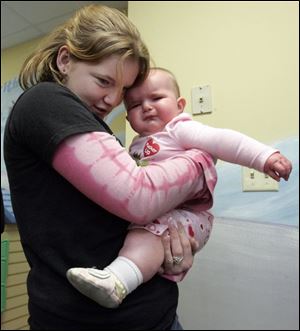 NBRN kids31p  3 01/23/2008   BLADE PHOTO/Lori King    Bedford High School sophomore Jessica Foust tries to comfort toddler Gabrielle Stout in the Toddler Trail room during MOPS (Mothers of Preschoolers) program at Crossroads Community Church in Ottawa Lake, Mich.