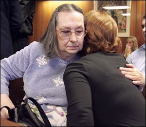 Charles Fackelman's mother, Margaret Mercurio, left, receives assurance after the verdict.