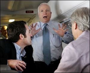 Sen. John McCain (R., Ariz.) jokes around with family friend Joe Harper, left, and campaign manager Rick Davis on the senator's s chartered plane the morning after his win in the Republican primary election in Florida.
