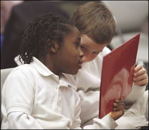 Slug: NBRW king31p C           The Blade/Jeremy Wadsworth     Date: 01/22/08                     Location: Toledo, Ohio. Caption: Left Ben Barnett, 6, and Noah Quigley, 10, both of Toledo talk after  reading  an excerpt from Dr. Martin Luther King Jr.'s 