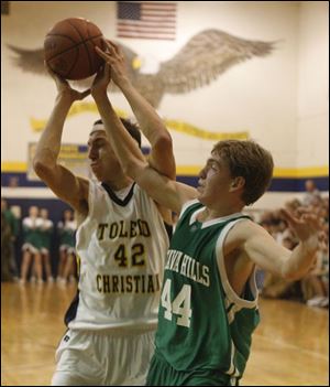 Toledo Christian s Ethan Michael, left, and Ottawa Hills  Philip Beans fight for a rebound.Michael averages 13.4 points. Beans averages 18.4 points and leads the TAAC in reboundng (11.9).