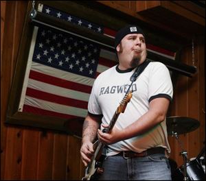 Jim Wheeler of the rock band 12 Dive, below, made up of former Northwood High School football players, performs during a fund-raiser for the Rangers.