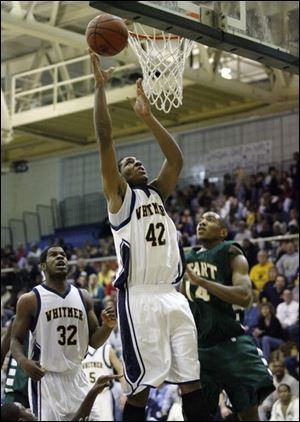 Antwan Willis scores for Whitmer with teammate KevinKoger trailing. Willis averages 13.8 points and 9.1 assists.
