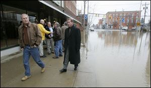 Gov. Ted Strickland surveys Main Street in Ottawa, flooded by the Auglaize and Blanchard rivers. He also visited Findlay, where 500 homes were damaged. (THE BLADE/DAVE ZAPOTOSKY)
<br>
<img src=http://www.toledoblade.com/graphics/icons/photo.gif> <b><font color=red>VIEW</b></font color=red>: <a href=