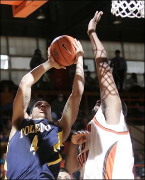 The long arm of Bowling Green's Otis Polk makes it difficult for Toledo's Jonathan Amos to get off a shot. Polk, a 6-9 sophomore, had 12 points, 5 rebounds and four blocked shots.